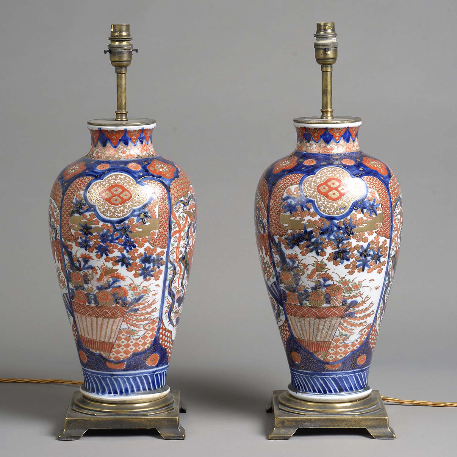 Pair of Japanese Imari Lamps on Gilt Metal Stands.